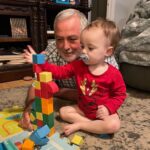 grandfather and baby playing with blocks