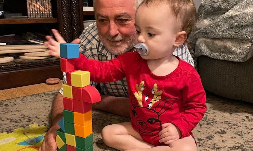 grandfather and baby playing with blocks