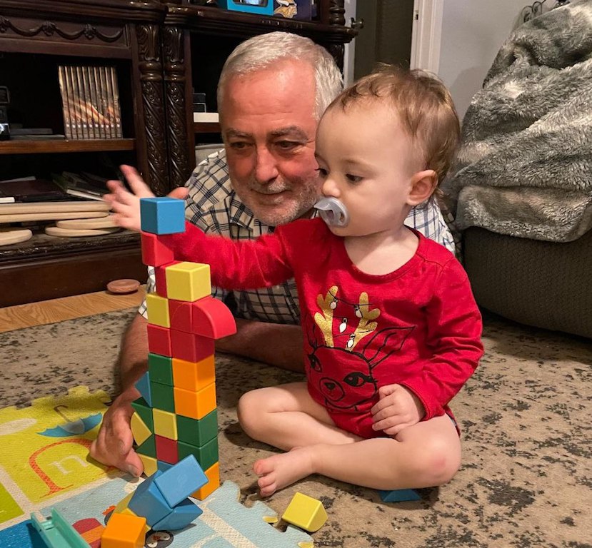 grandfather and baby playing with blocks