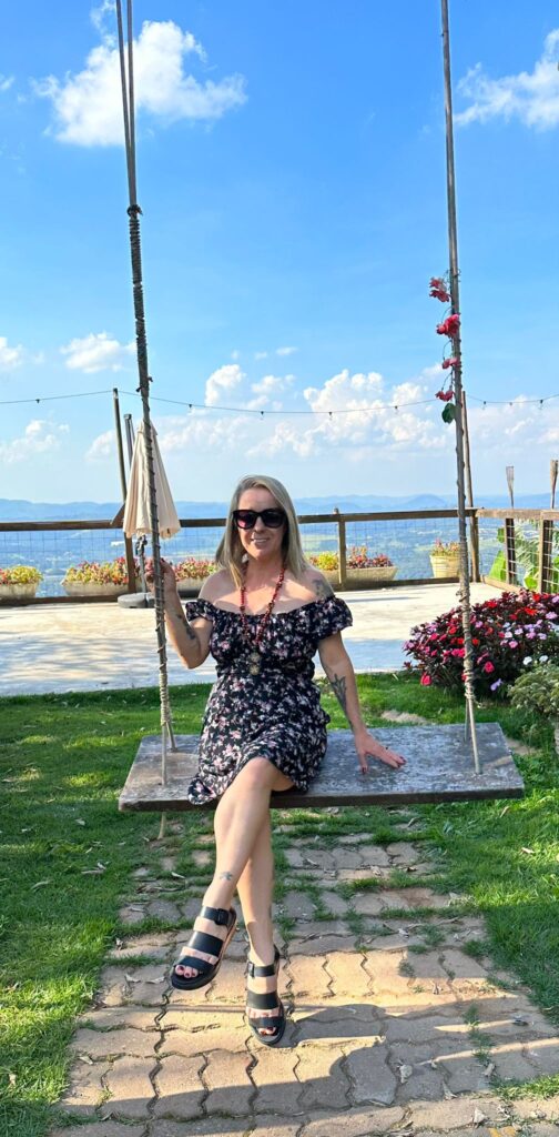 Woman over 50 on swing at the ocean