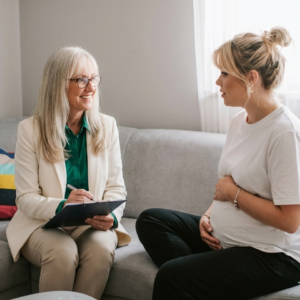 Dr Jimi Francis consulting with a pregnant woman